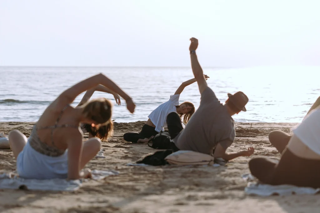 Participants of Alexandras Meffert luxury yoga retreat in a yoga session in a private beach in Sicily, Italy