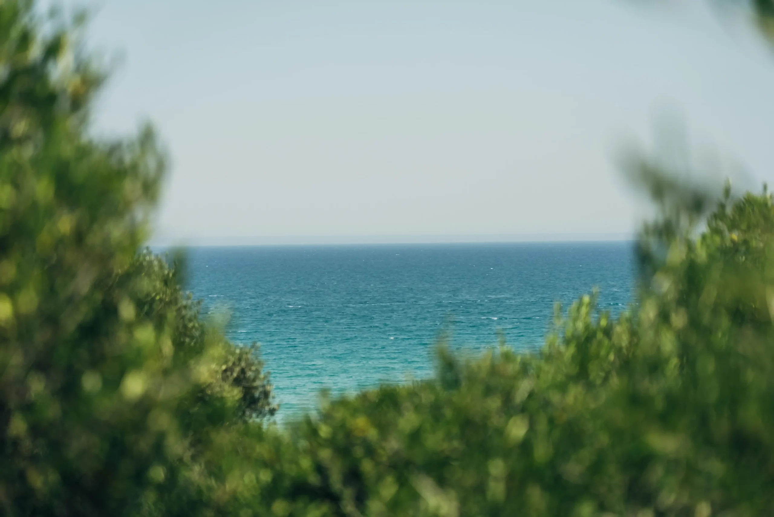 view on the clear and blue water of the private beach for the yoga sessions of the luxury yoga retreat in Sicily by Alexandra Meffert