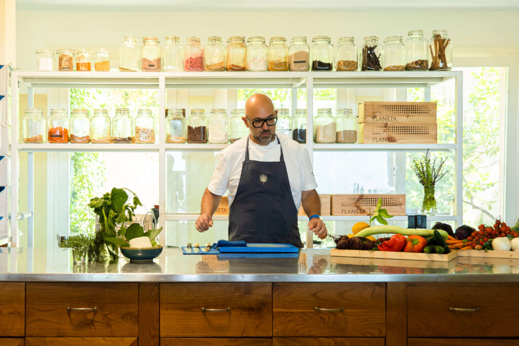 Sicily luxury yoga retreats portrait of Chef in his kitchen. Pumilia designs every meal for the participants of the luxury yoga retreat