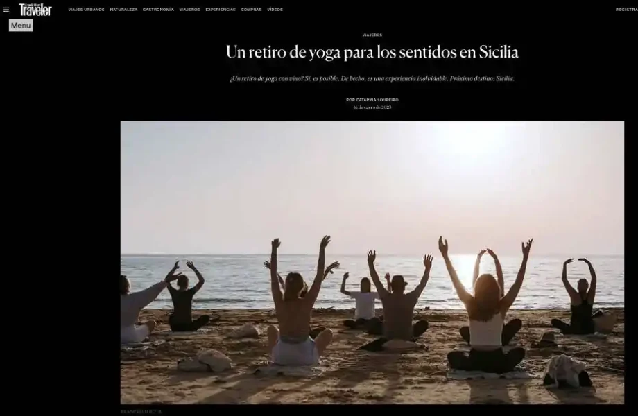 Article in Conde Nast Traveller about the luxury yoga retreat by Light Space Movement with people doing the sun pose on a beach in Sicily