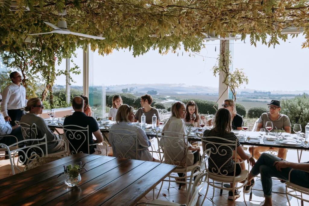 luxury-sicily-yoga-retreats-participants having lunch with wine in the Foresteria 