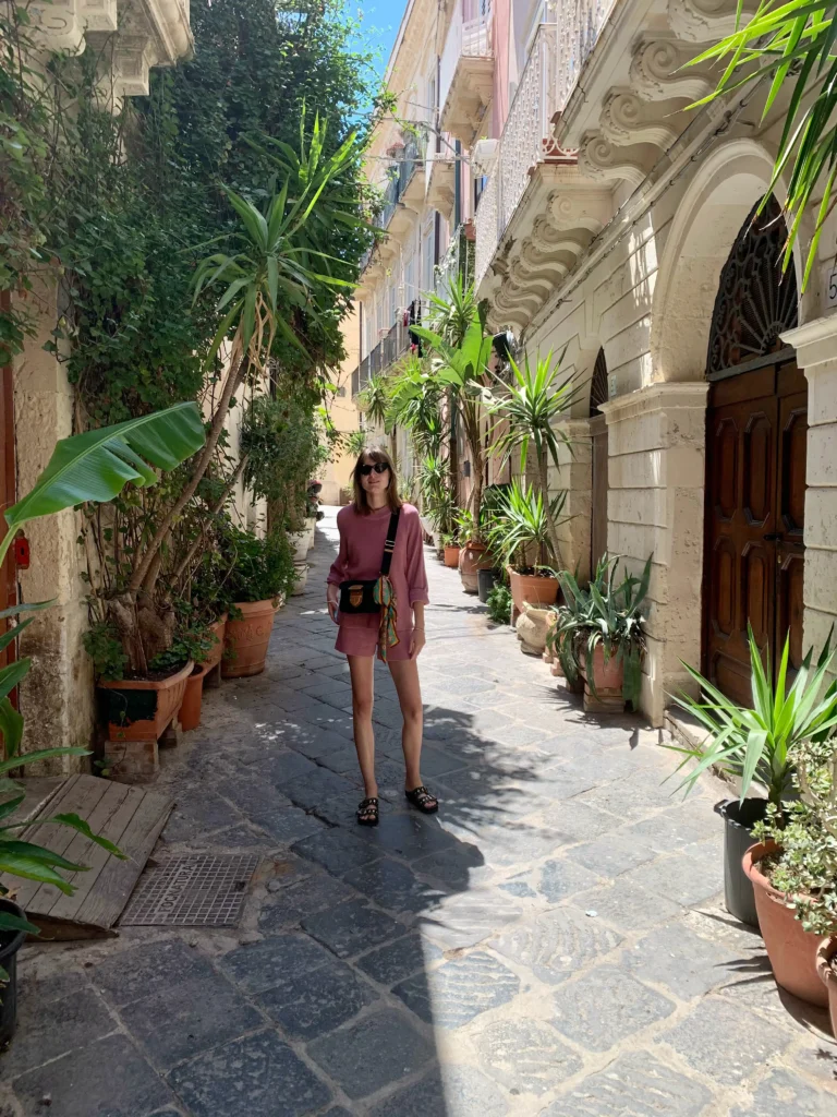 Private yoga retreats Ortigia, Syracuse. A beautiful street with a lot of plants and Alexandra Meffert